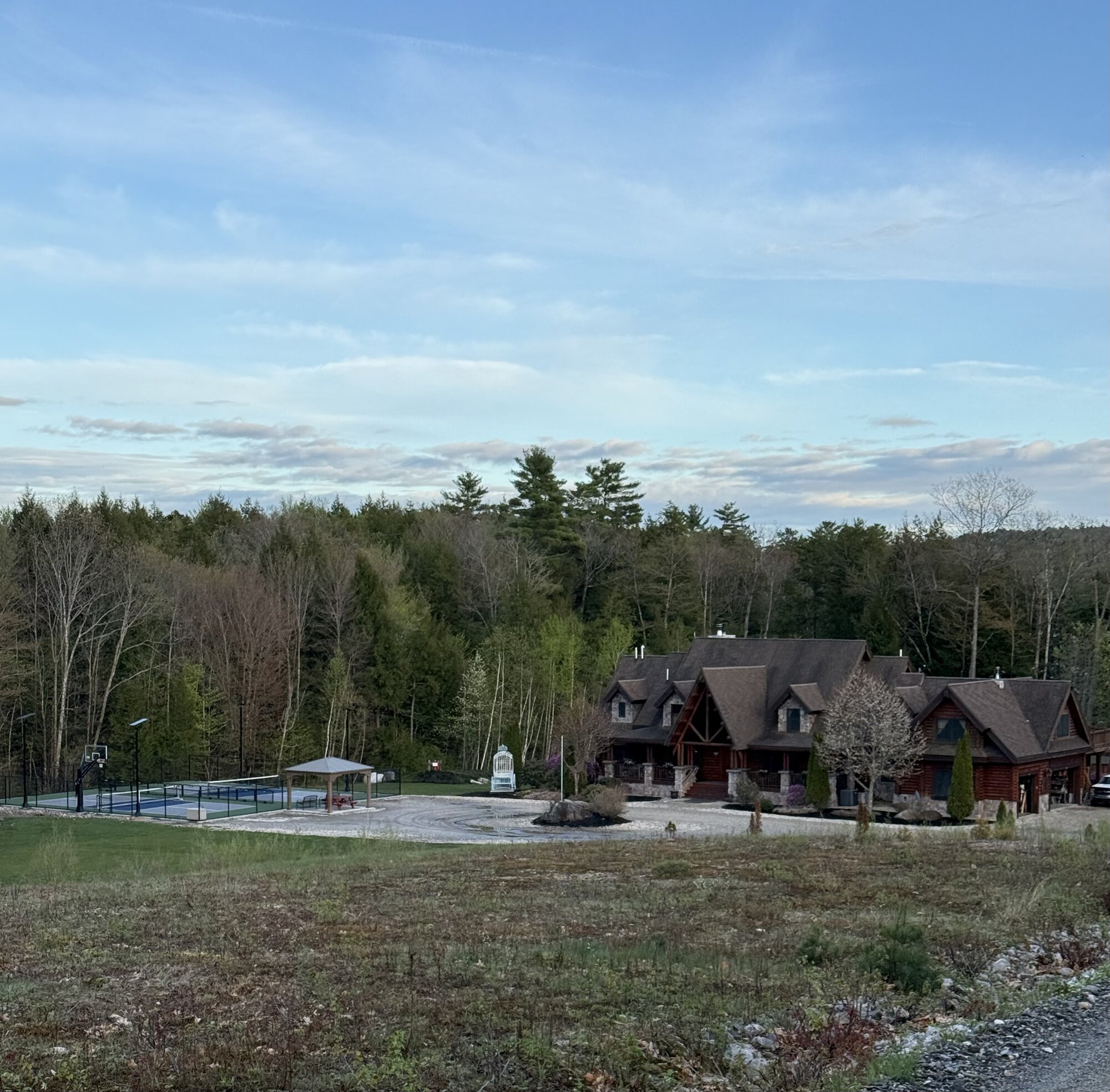 The lodge with the new pickleball pavilion at sunset